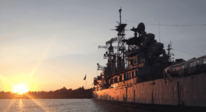 image of large naval ship at sunset